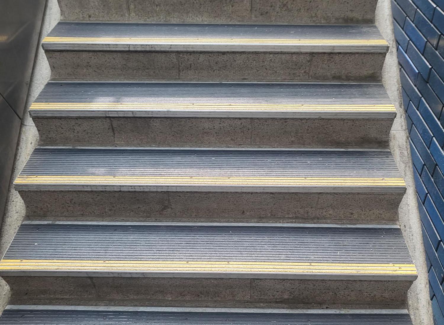 An up-close view of the Nystrom product, Renovation Abrasive Nosing, in use on stairs.
