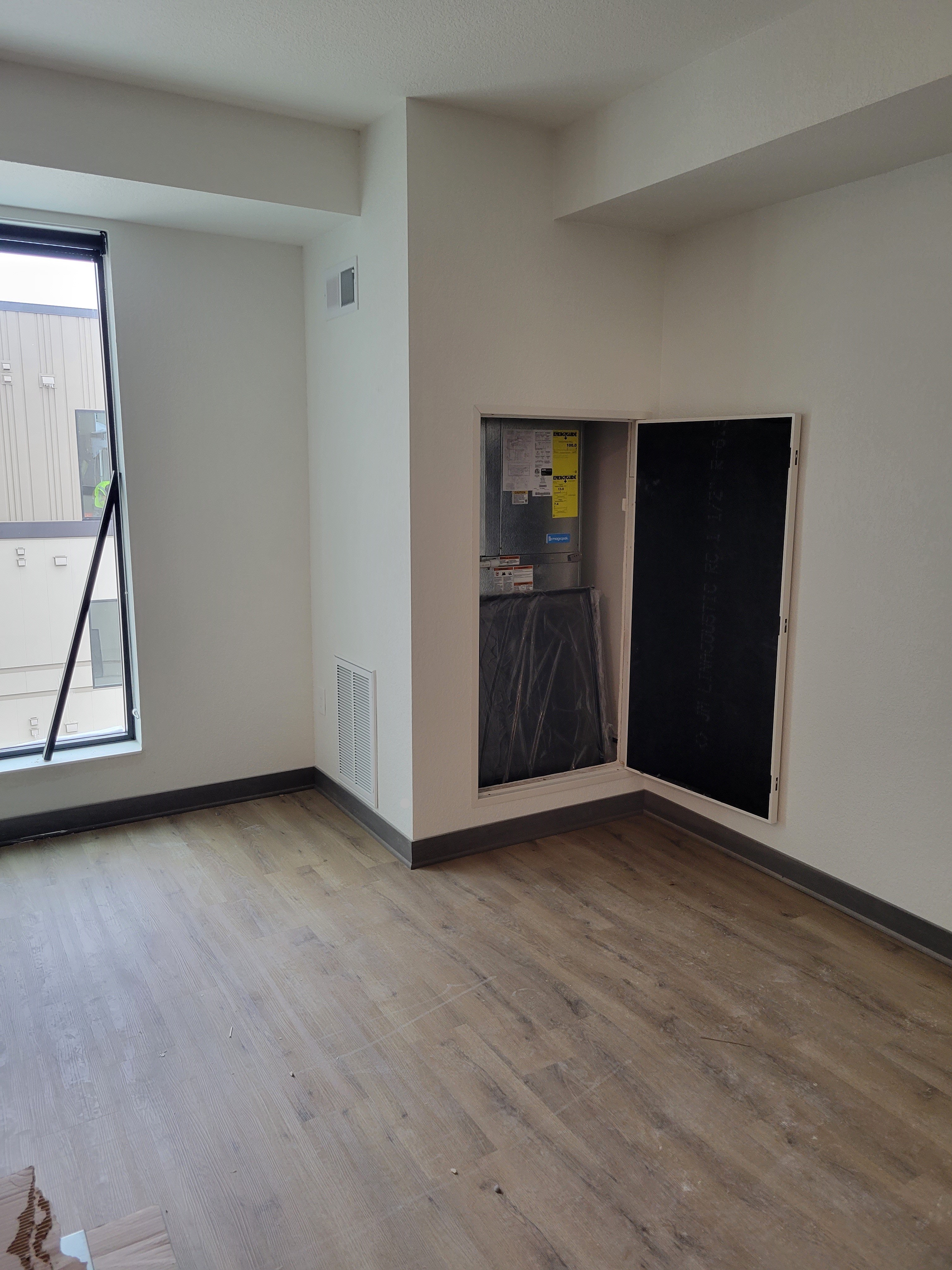 An in-person view of an installed HVAC access door in a home.