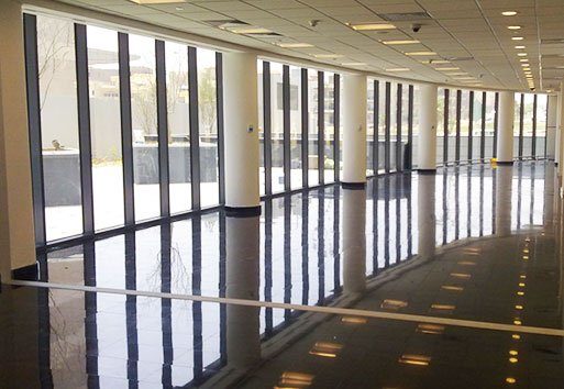 The interior of BNP Paribas Bank, displaying the Nystrom product, Expansion Joint System, is surrounded by tall windows.
