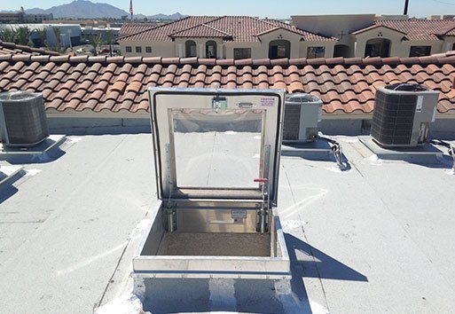 An above view of a roof displaying the use of the Nystrom product; Sunlit Roof Hatches